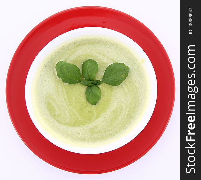 Pea and mozzarella soup decorated with basil. Pea and mozzarella soup decorated with basil