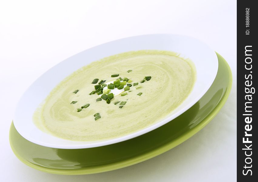 Pea and mozzarella soup decorated with cream and parsley. Pea and mozzarella soup decorated with cream and parsley