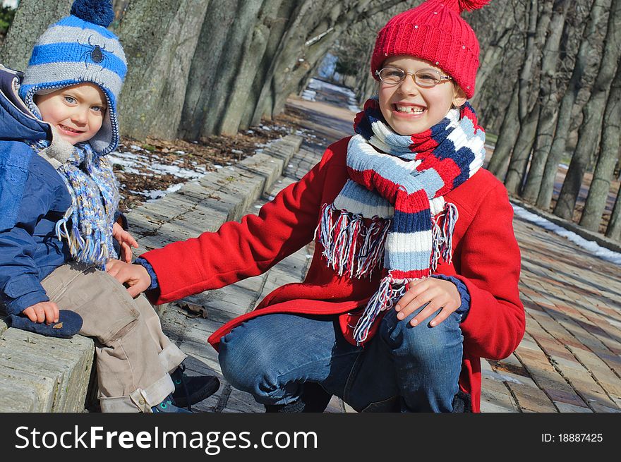 Lucky sister with her ​​brother for a walk in the Spring Park