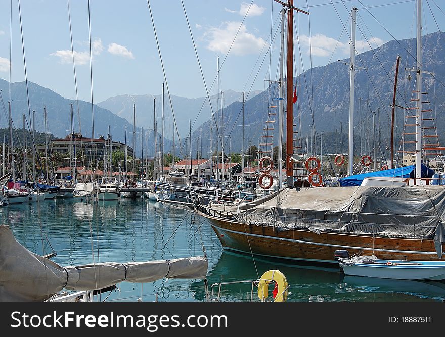 The port, yachts and mountains in Turkey. The port, yachts and mountains in Turkey.