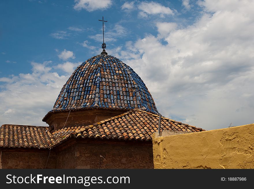 Old churches colored tile roof against blue sky