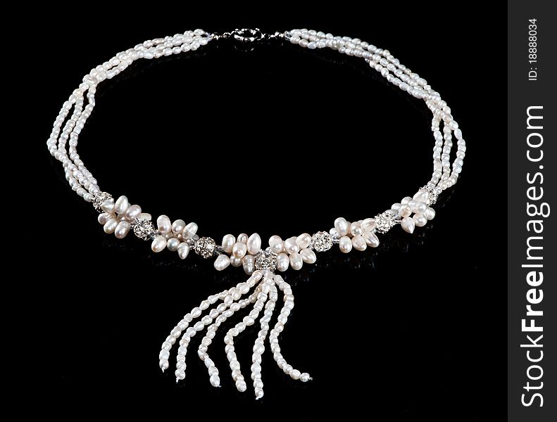 Beautiful necklace of pearls and diamonds in a black background. Beautiful necklace of pearls and diamonds in a black background