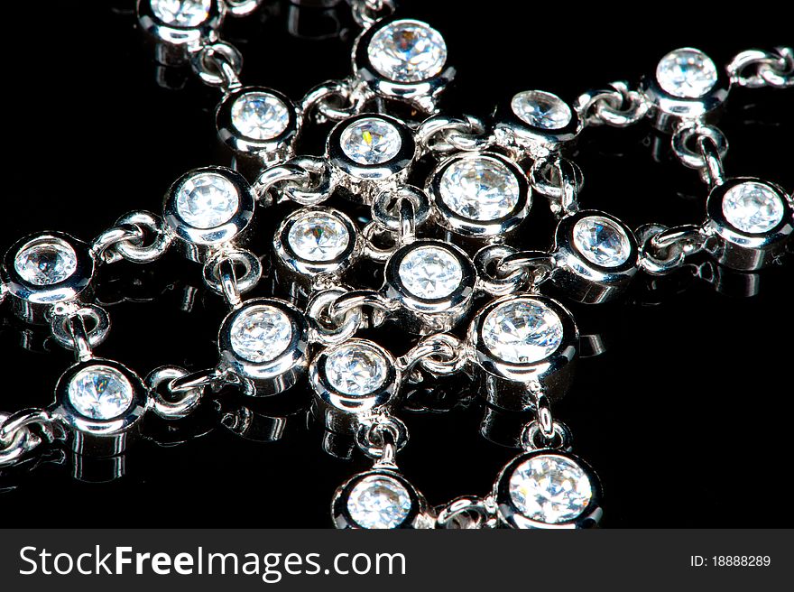 Close-up of a beautiful necklace of diamonds in a black background. Close-up of a beautiful necklace of diamonds in a black background