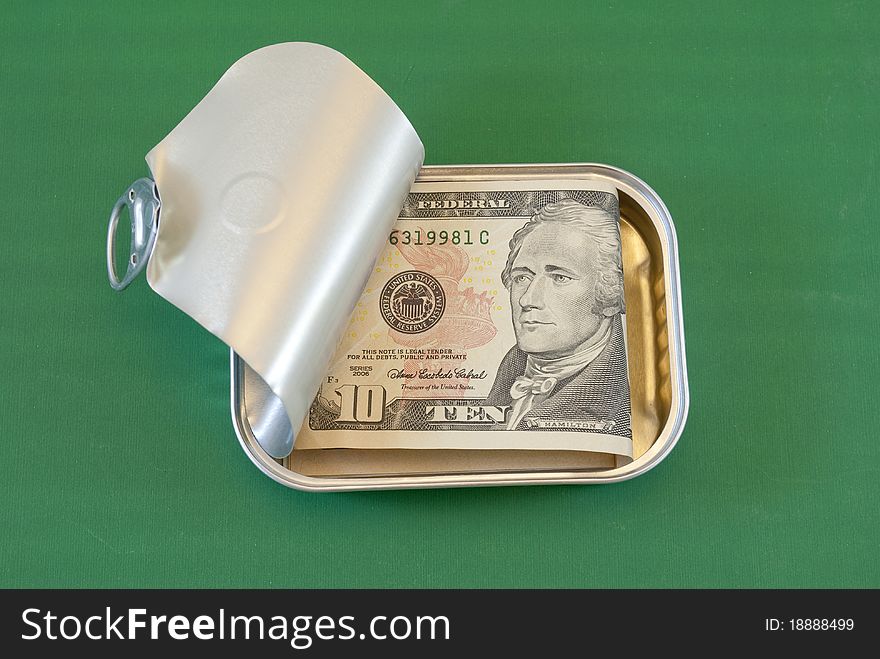 Tin of sardines with ten-dollar bill. Tin of sardines with ten-dollar bill