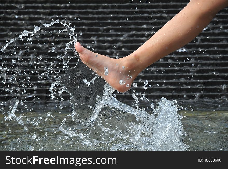 Leg Kicking Up Water Creating Water Droplets And Spray