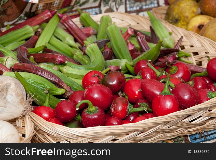 Basket of fresh organic okra and cherry peppers