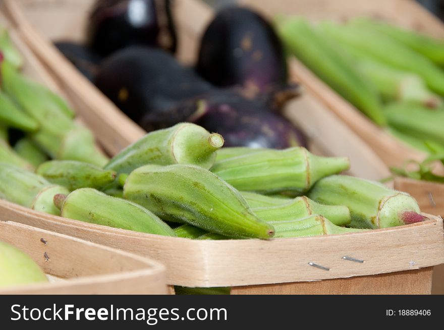 Baskets of fresh organic okra and eggplant