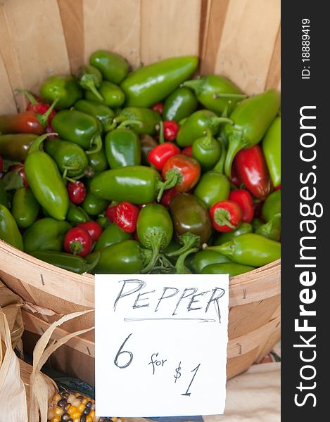 Basket of fresh organic green and red chili peppers