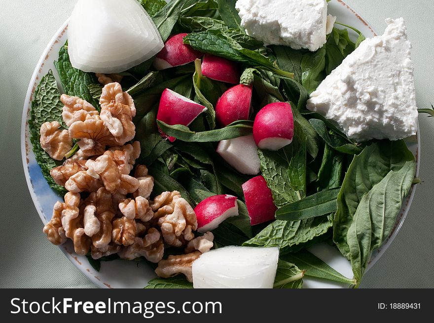 Appetizer of walnuts, radish, onion, and feta cheese. Appetizer of walnuts, radish, onion, and feta cheese