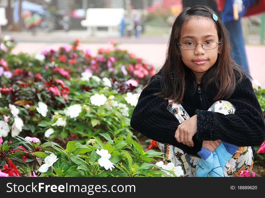 Asian Girl At A Flower Garden