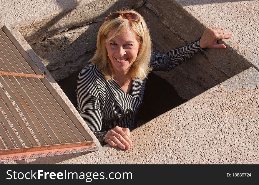 Senior Woman Climbing Out Of A Hole.