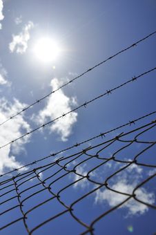 Fence With Barbed Wire Under Blue Sky Royalty Free Stock Photography Fence With Barbed Wire Under Blue Sky Royalty Free Stock Photography