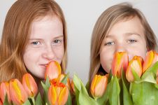 Two Young Girls Are Holding Pink Orange Tulips Royalty Free Stock Photo