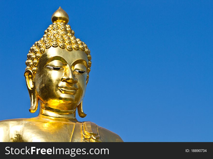 The smiling golden buddha statue under the open sky. The smiling golden buddha statue under the open sky