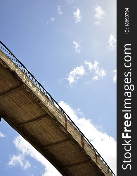 Concrete bridge under the blue sky with clouds. Concrete bridge under the blue sky with clouds