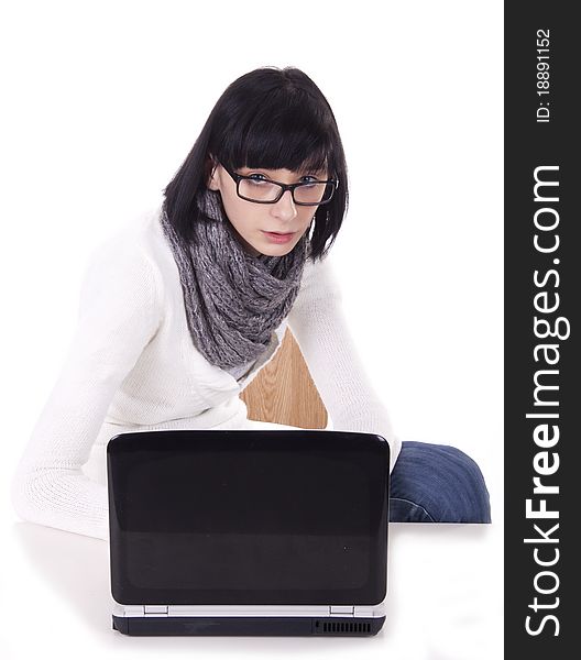 Brunette woman sits at a computer on white background