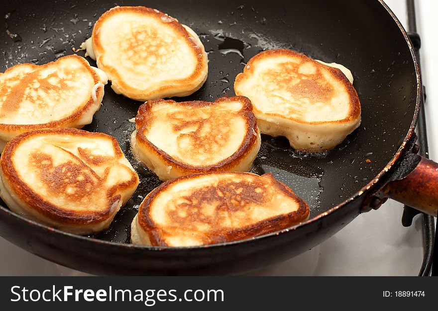 Pancakes frying in a pan