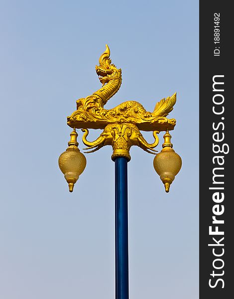 The golden naga on light pillar lantern, Thailand. The golden naga on light pillar lantern, Thailand