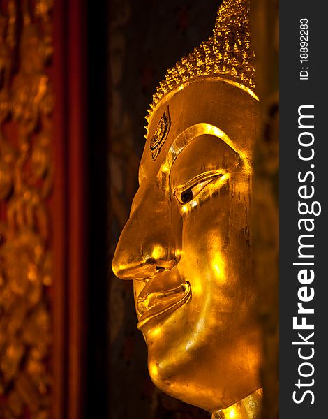 The closeup of smiling golden buddha statue, Thailand. The closeup of smiling golden buddha statue, Thailand