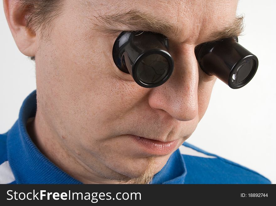 Man is using two loupes in the same time. Man is using two loupes in the same time