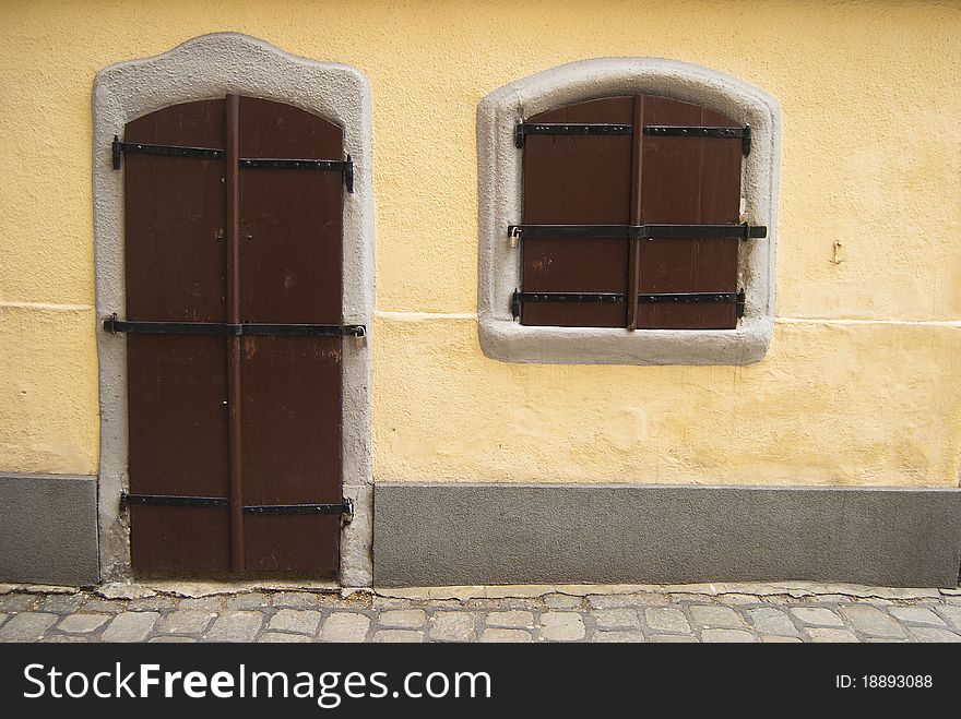 An old fairy styled house with locked wooden door and window. An old fairy styled house with locked wooden door and window