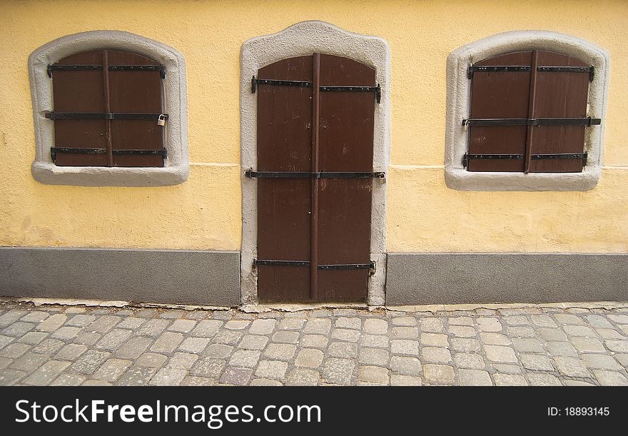 An old fairy styled house with locked wooden door and windows. An old fairy styled house with locked wooden door and windows