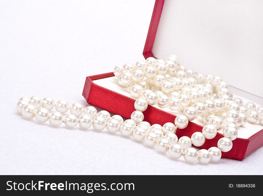 Pearls in a red gift box. Pearls in a red gift box