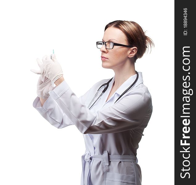The girl in medical gloves with a syringe in the studio on a white background