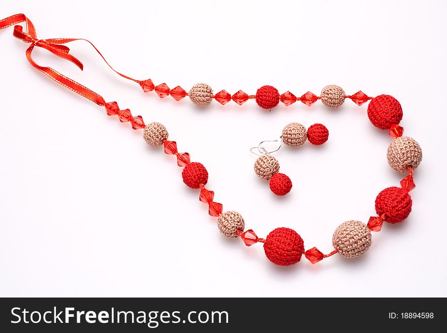 Necklace of beads knitted on a white background