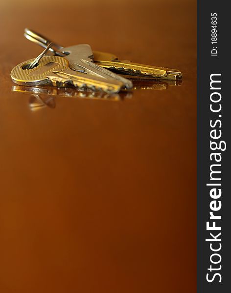 Bunch of keys , open the door, lying on the table, close up, blurred background. Bunch of keys , open the door, lying on the table, close up, blurred background