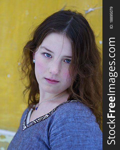 Young girl with wavy hair on the yellow background. Young girl with wavy hair on the yellow background