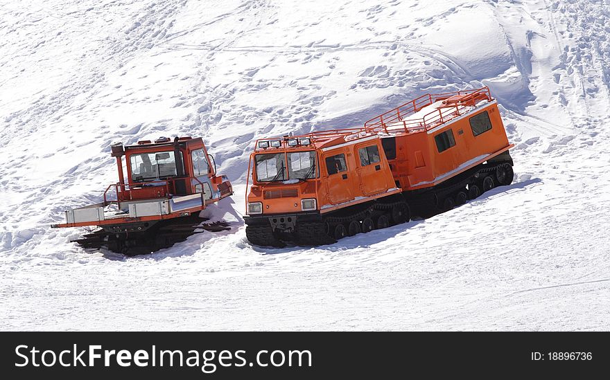 Winter special transportation orange vehicles for supplying purposes. Winter special transportation orange vehicles for supplying purposes