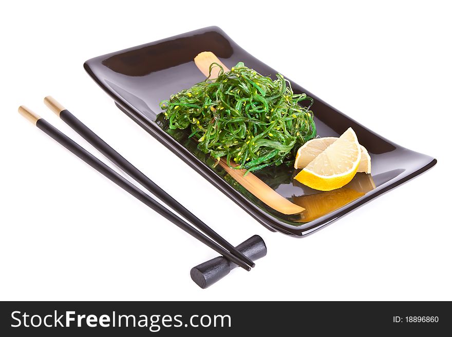 Black plate with chuka salad and chopsticks