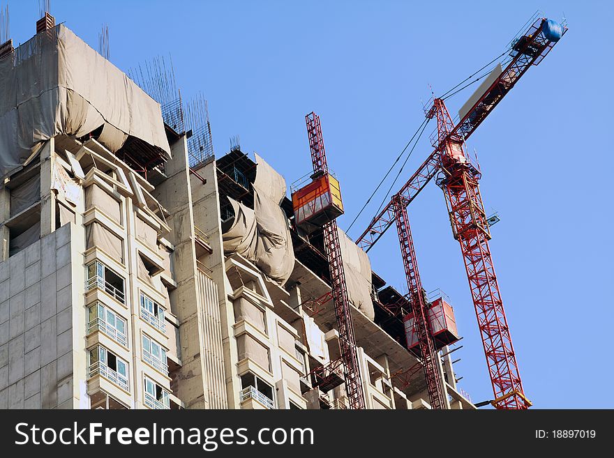 Condominium apartment construction site in bright blue sky in Bangkok urban area