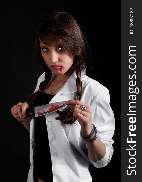 Crazy nurse holds a bloody knife