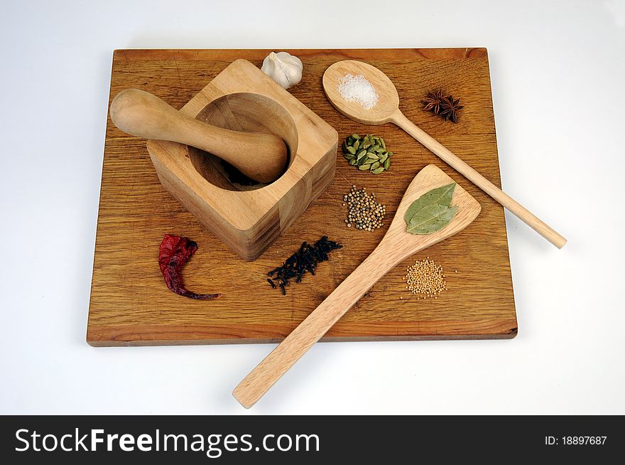 Full view of cooking ingredients and utensils, including spoon, spatula and pestle and mortar