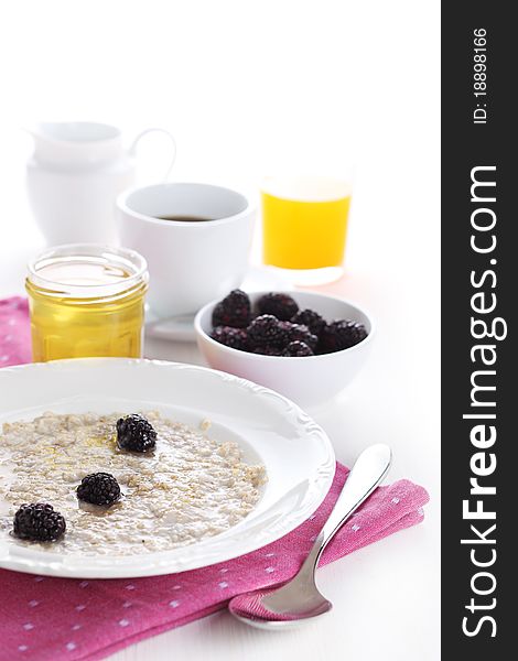 Oatmeal with honey and blackberry isolated on white background - breakfast