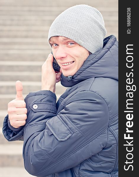 Smiling young man talking on the phone.