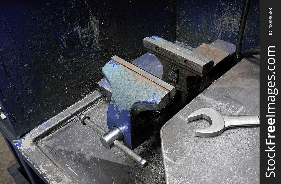 Old Vice and wrench on a Steel workbench