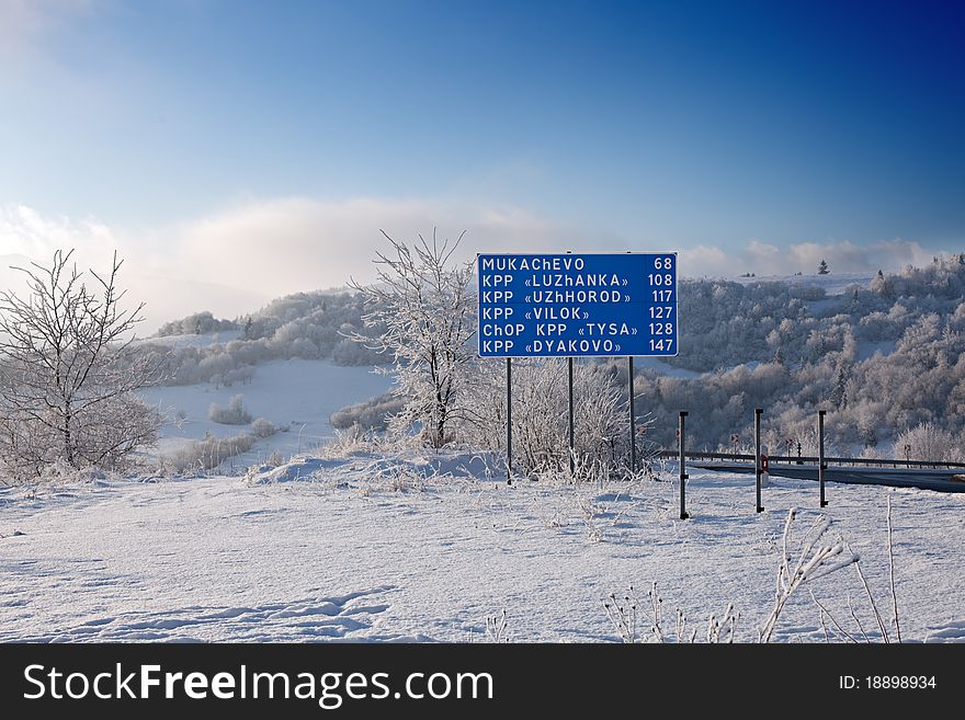 Road trips, travel, and sign: road sign and mountain landscape. Road trips, travel, and sign: road sign and mountain landscape