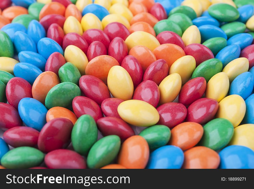 Many colored candy on a white background