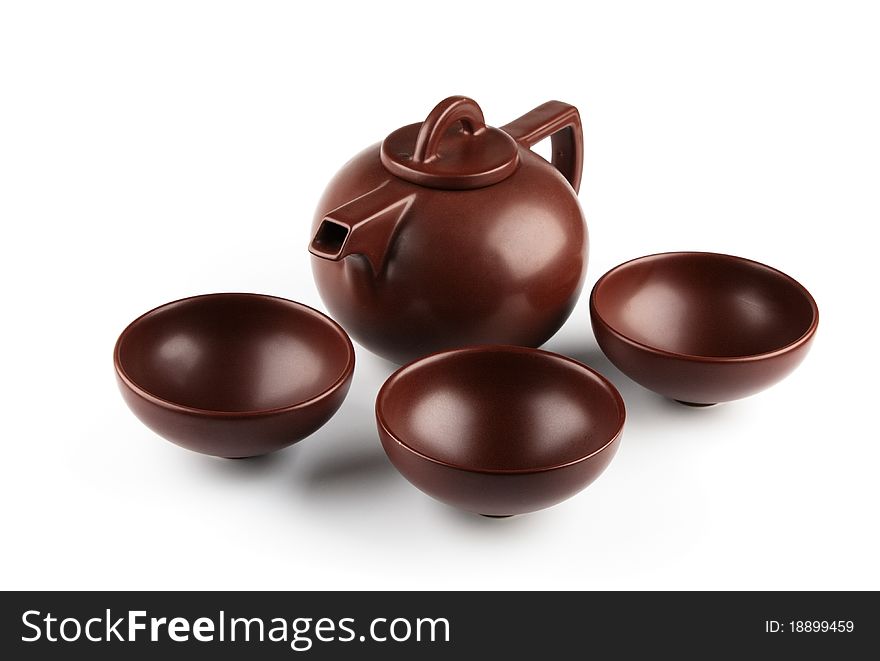 Brown ceramic teapot and cups isolated on white background. Brown ceramic teapot and cups isolated on white background