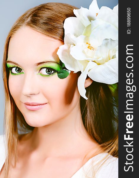 Portrait of a beautiful young woman with spring make-up. Beauty, fashion. Portrait of a beautiful young woman with spring make-up. Beauty, fashion.