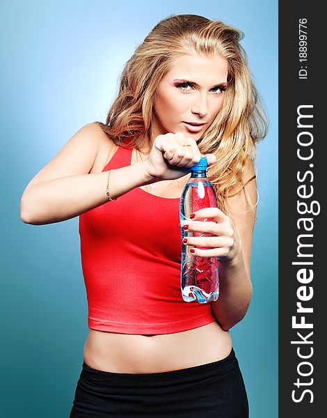 Shot of a sporty young woman drinking water after training. Active lifestyle, wellness. Shot of a sporty young woman drinking water after training. Active lifestyle, wellness.