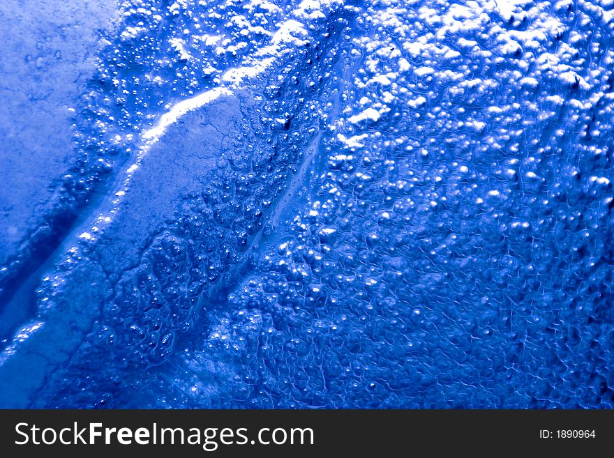 Detail of a bubbled glass with blu natural gradient. Detail of a bubbled glass with blu natural gradient