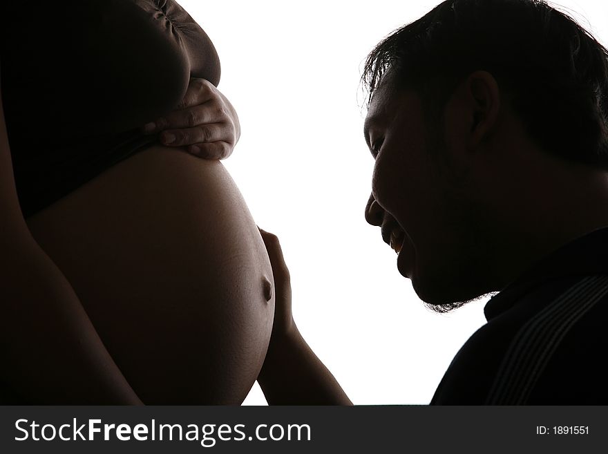 Silhouette of a father talks to his unborn baby. Silhouette of a father talks to his unborn baby
