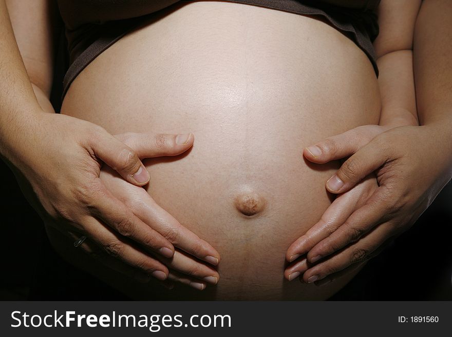 Pregnant woman & husband with their hands on a belly. Pregnant woman & husband with their hands on a belly