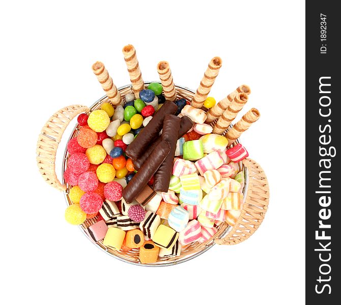 Basket with various sweets and the cookies, isolated