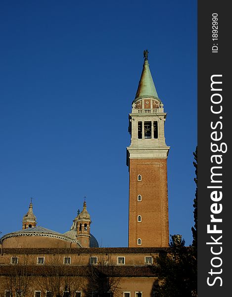 The bell tower of the church of San Giorgio Maggiore, Venice, in the early morning light. The bell tower of the church of San Giorgio Maggiore, Venice, in the early morning light