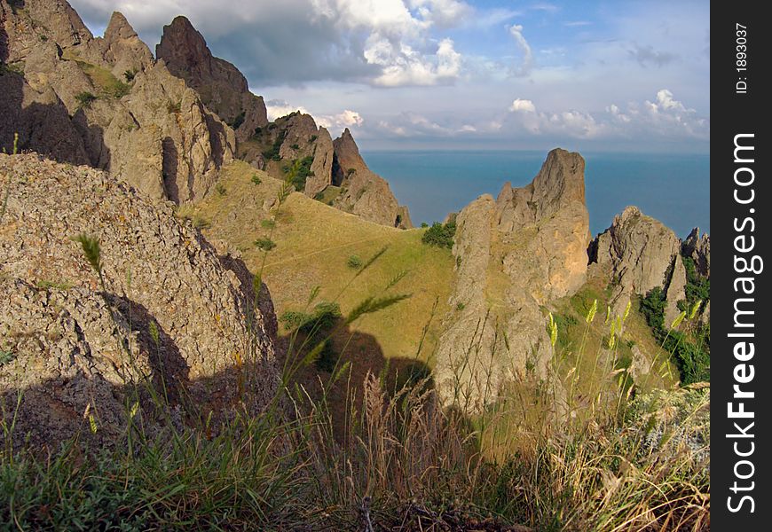 Rocks of Kara Dag reserve (Crimea, Ukraine) and sea on  background